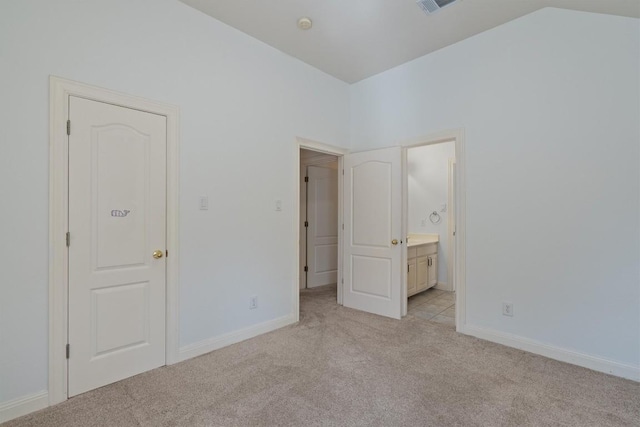 10303 Spicewood Pkwy, Austin, TX 78750 - unfurnished bedroom with light carpet, ensuite bathroom, and vaulted ceiling