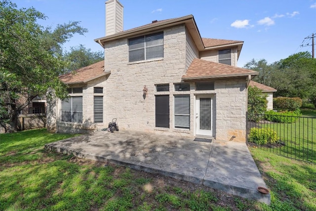 10303 Spicewood Pkwy, Austin, TX 78750 - rear view of property featuring stone siding, a patio, a chimney, and a shingled roof
