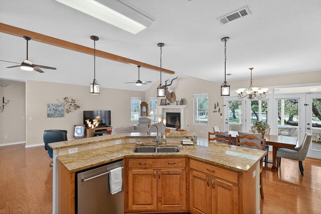 127 W Stonecastle Dr, Granite Shoals, TX 78654 - kitchen featuring open floor plan, stainless steel dishwasher, a ceiling fan, a fireplace, and light wood-type flooring