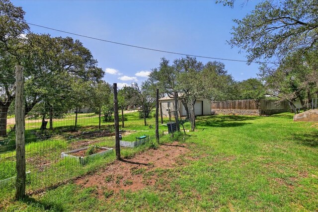 127 W Stonecastle Dr, Granite Shoals, TX 78654 - view of yard featuring a garden, a garage, and a storage shed