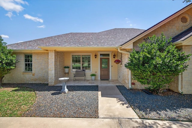 127 W Stonecastle Dr, Granite Shoals, TX 78654 - view of front facade with stone siding, roof with shingles, and a porch