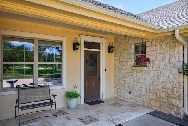 127 W Stonecastle Dr, Granite Shoals, TX 78654 - entrance to property with stone siding, a shingled roof, and a porch