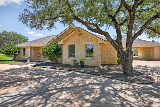 127 W Stonecastle Dr, Granite Shoals, TX 78654 - ranch-style house with concrete driveway, stone siding, and a carport