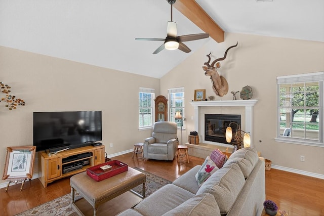 127 W Stonecastle Dr, Granite Shoals, TX 78654 - living area with plenty of natural light, beam ceiling, a tile fireplace, a ceiling fan, and wood finished floors