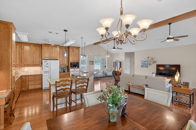 127 W Stonecastle Dr, Granite Shoals, TX 78654 - dining room featuring a ceiling fan, vaulted ceiling, a chandelier, and light wood finished floors