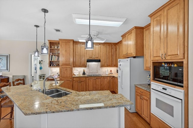 127 W Stonecastle Dr, Granite Shoals, TX 78654 - kitchen with white appliances, open shelves, a breakfast bar, a spacious island, and light stone countertops