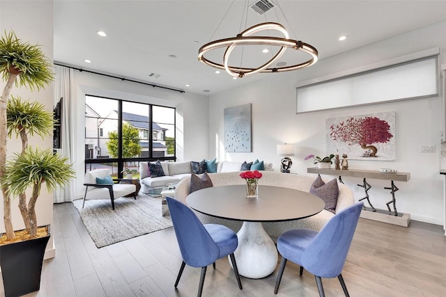 6702 Adeline Way Unit 34, Austin, TX 78746 - dining area featuring wood finished floors, a chandelier, and recessed lighting