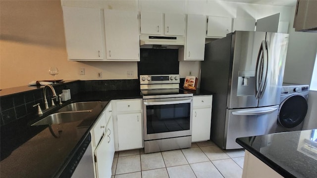 7122 Wood Hollow Dr Unit 41, Austin, TX 78731 - kitchen featuring appliances with stainless steel finishes, under cabinet range hood, washer / clothes dryer, white cabinets, and light tile patterned floors