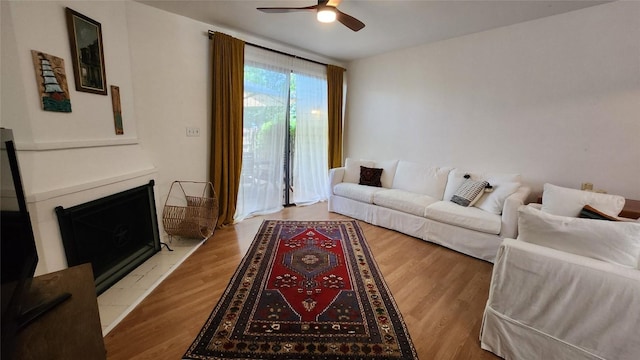 7122 Wood Hollow Dr Unit 41, Austin, TX 78731 - living room featuring ceiling fan, wood finished floors, and a fireplace with raised hearth