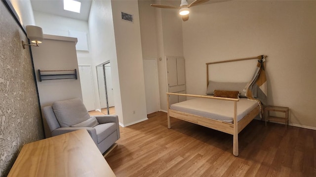 7122 Wood Hollow Dr Unit 41, Austin, TX 78731 - bedroom with wood finished floors, a high ceiling, and ceiling fan