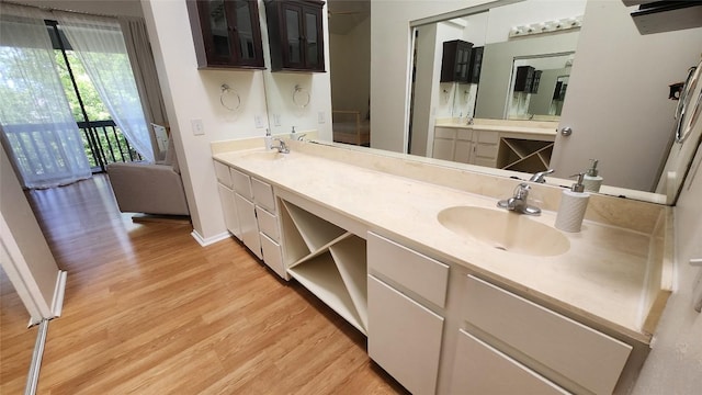 7122 Wood Hollow Dr Unit 41, Austin, TX 78731 - bathroom featuring wood finished floors and double vanity