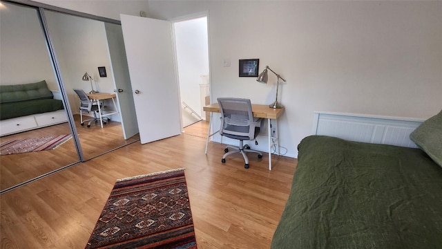 7122 Wood Hollow Dr Unit 41, Austin, TX 78731 - bedroom with wood finished floors, an office area, and a closet