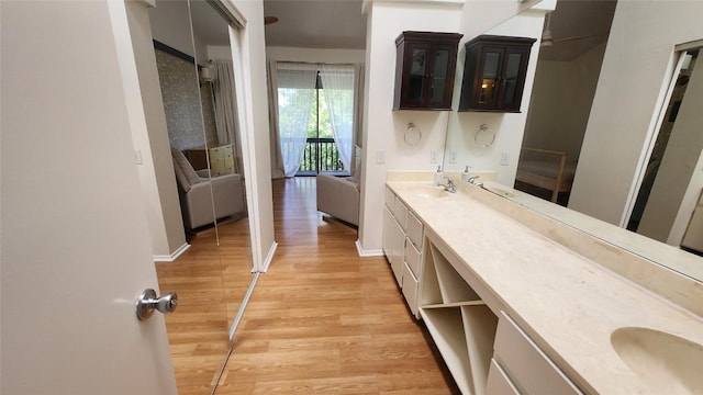 7122 Wood Hollow Dr Unit 41, Austin, TX 78731 - bathroom featuring wood finished floors and double vanity