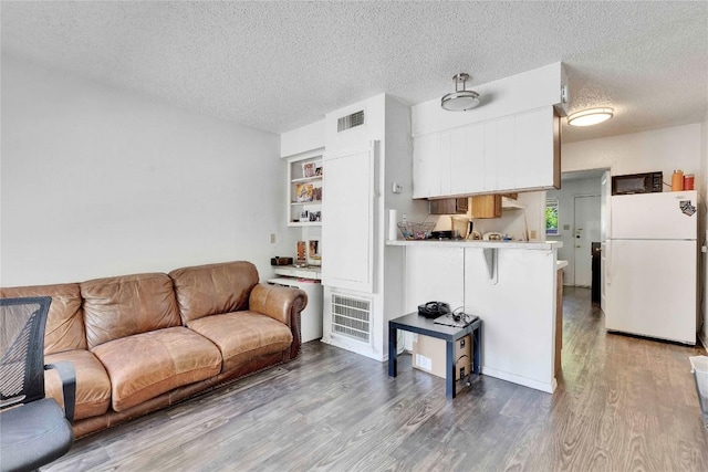 2801 Hemphill Park Unit A102, Austin, TX 78705 - living room featuring a textured ceiling and wood finished floors
