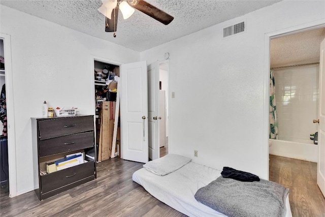 2801 Hemphill Park Unit A102, Austin, TX 78705 - bedroom with a textured ceiling, wood finished floors, and ceiling fan