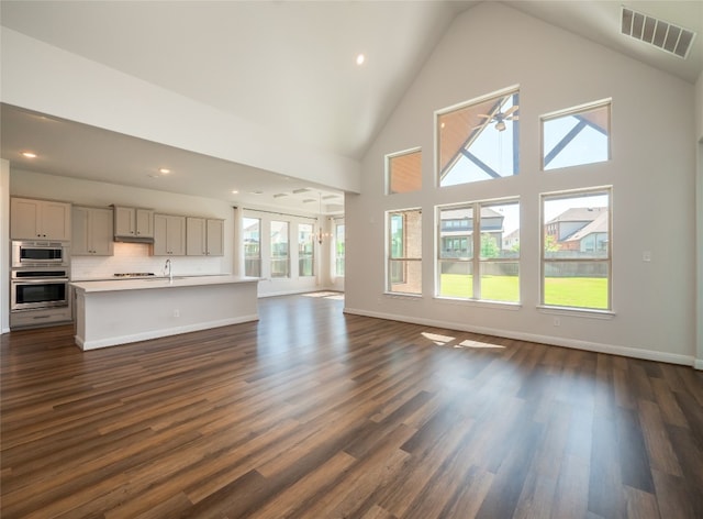 2320 Lucky Ln, Leander, TX 78641 - unfurnished living room featuring high vaulted ceiling, dark wood finished floors, recessed lighting, and a ceiling fan