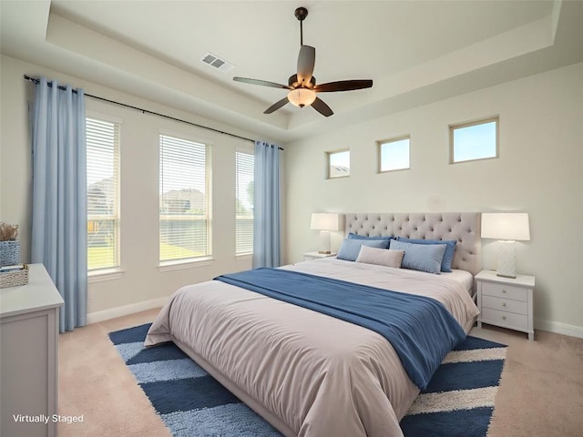 2320 Lucky Ln, Leander, TX 78641 - bedroom featuring a tray ceiling, light colored carpet, and a ceiling fan