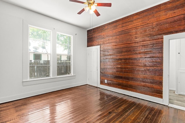 102 S Western Ave, Lampasas, TX 76550 - spare room featuring wood walls, a ceiling fan, and wood finished floors