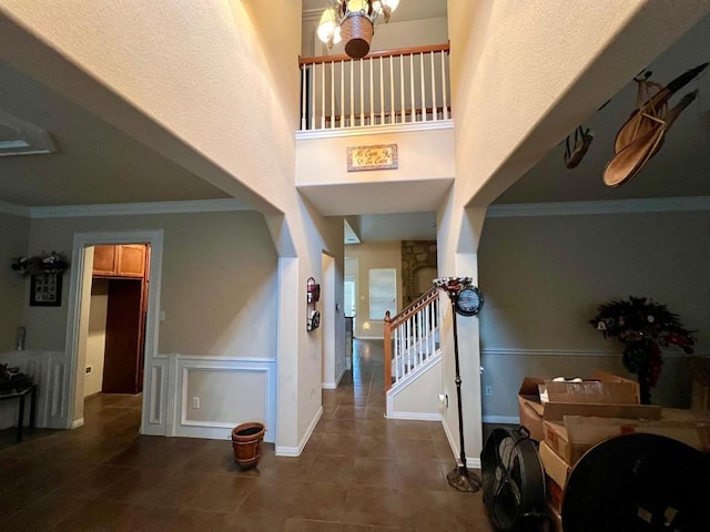395 Spring Dr, Kyle, TX 78640 - foyer entrance featuring tile patterned floors, crown molding, stairway, and a towering ceiling