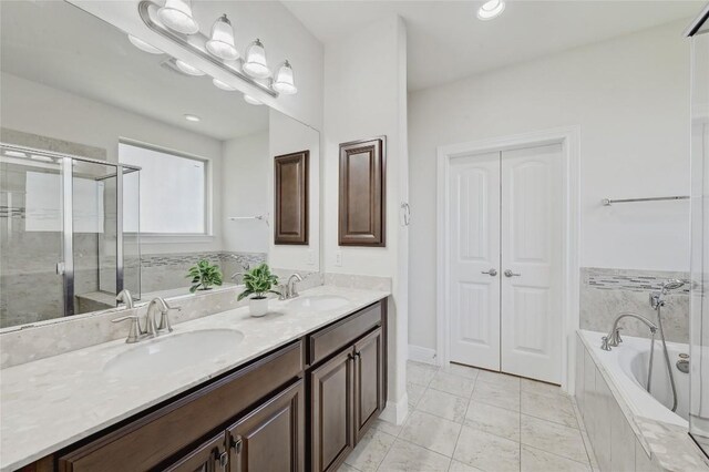 2232 Skippy Cv, Leander, TX 78641 - bathroom with double vanity, a garden tub, and a shower stall