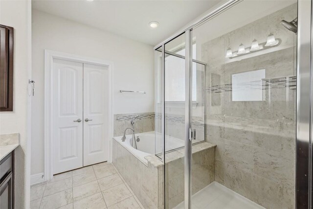 2232 Skippy Cv, Leander, TX 78641 - full bath with a garden tub, vanity, a stall shower, and tile patterned flooring