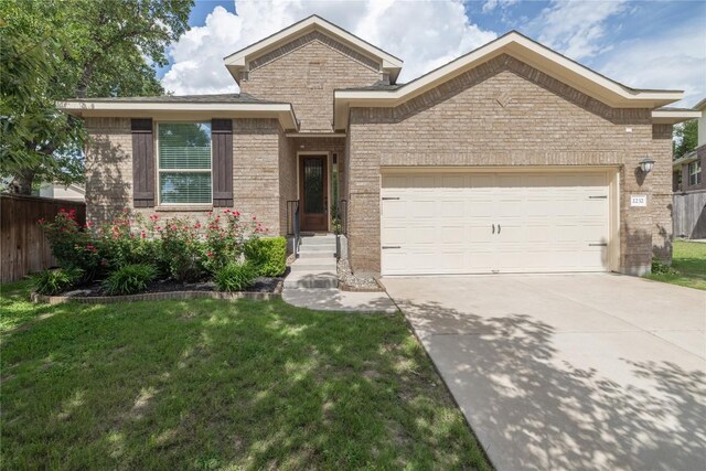 2232 Skippy Cv, Leander, TX 78641 - view of front of home featuring brick siding, an attached garage, and concrete driveway