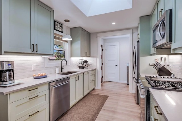 1509 Ridgehaven Dr, Austin, TX 78723 - kitchen with appliances with stainless steel finishes, recessed lighting, light countertops, decorative backsplash, and light wood-style flooring
