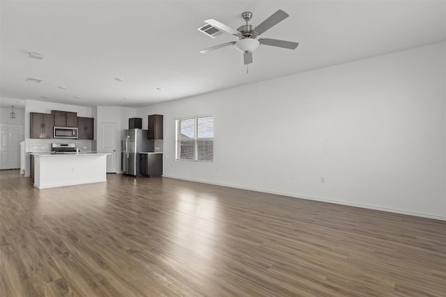 11825 Monterosso Dr, Austin, TX 78754 - unfurnished living room with dark wood-style flooring and a ceiling fan