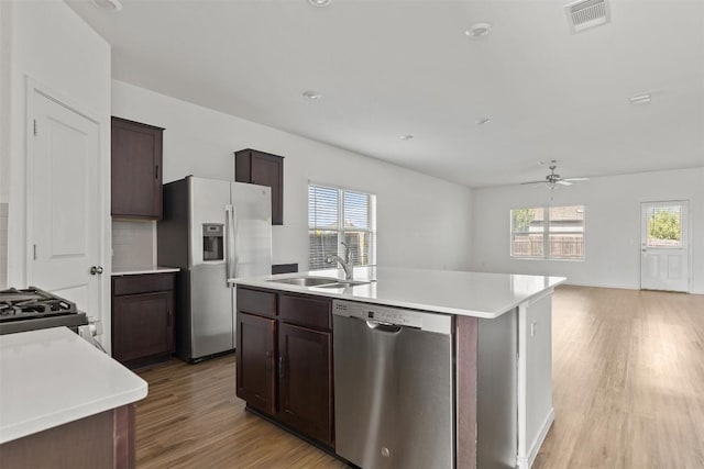11825 Monterosso Dr, Austin, TX 78754 - kitchen featuring appliances with stainless steel finishes, light wood-style floors, ceiling fan, and healthy amount of natural light