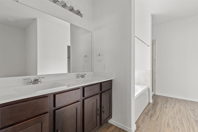 11825 Monterosso Dr, Austin, TX 78754 - bathroom featuring wood finished floors, double vanity, a tub to relax in, and a shower