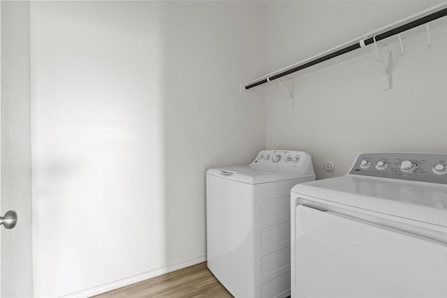 11825 Monterosso Dr, Austin, TX 78754 - laundry room with washer and clothes dryer and light wood-style floors