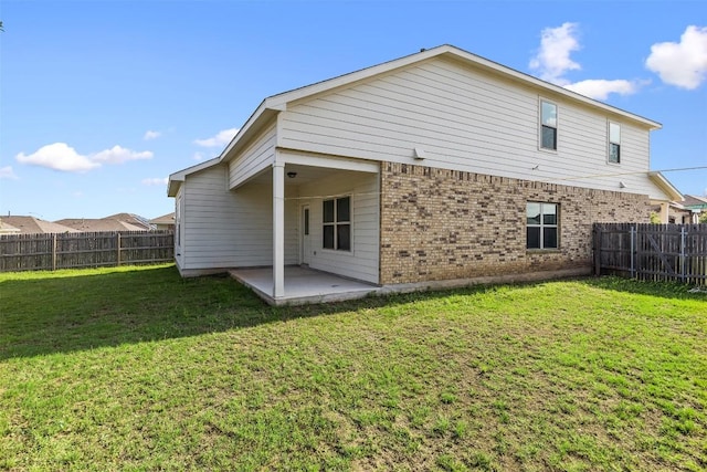 11825 Monterosso Dr, Austin, TX 78754 - back of house featuring brick siding, a patio area, and a fenced backyard