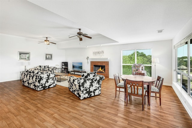 2806 Truman Cv, Lago Vista, TX 78645 - living room with light wood-type flooring, a ceiling fan, and a tile fireplace