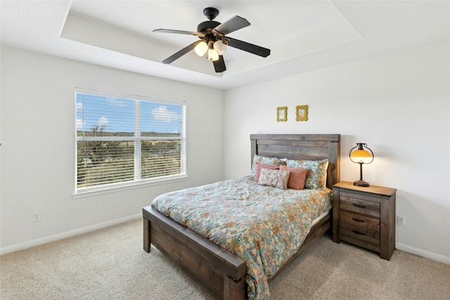 2806 Truman Cv, Lago Vista, TX 78645 - bedroom with carpet, a raised ceiling, and a ceiling fan
