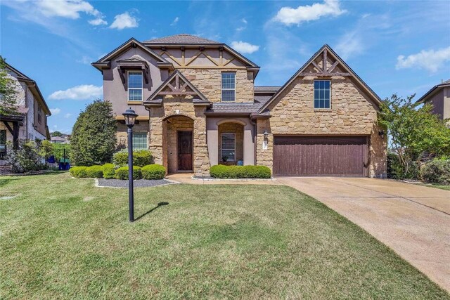 110 Waverly Spire Ct, Austin, TX 78738 - view of front of property with stone siding, concrete driveway, a front lawn, an attached garage, and stucco siding