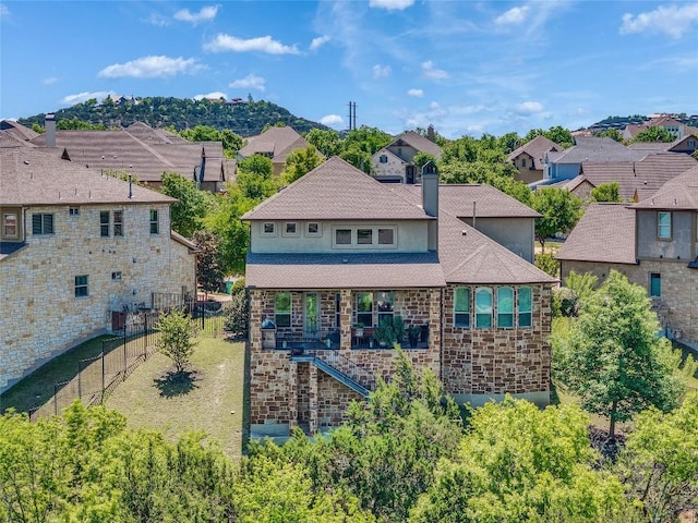 110 Waverly Spire Ct, Austin, TX 78738 - back of house with a residential view, stairway, a chimney, a shingled roof, and stone siding