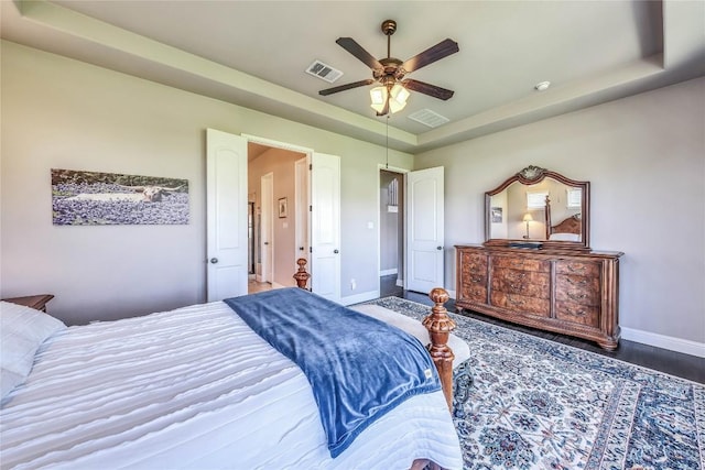 110 Waverly Spire Ct, Austin, TX 78738 - bedroom featuring a tray ceiling, ceiling fan, and wood finished floors