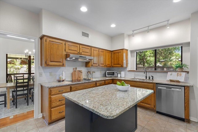 3004 Quail Run Dr, Round Rock, TX 78681 - kitchen featuring dishwasher, under cabinet range hood, track lighting, brown cabinetry, and recessed lighting