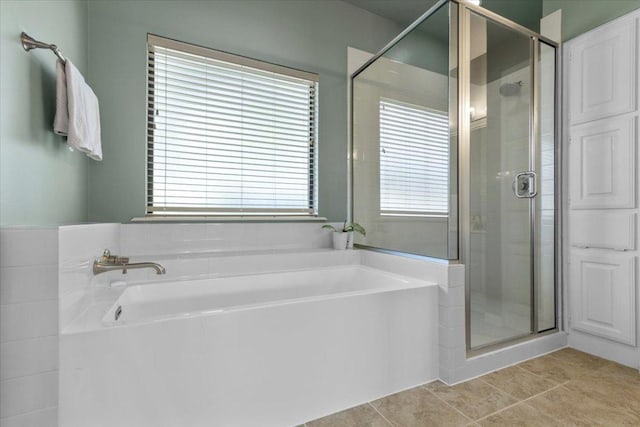 3004 Quail Run Dr, Round Rock, TX 78681 - bathroom featuring a garden tub, a shower stall, and tile patterned floors