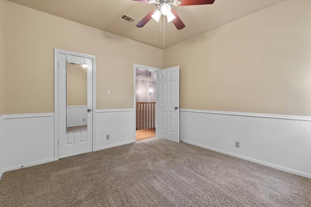 3004 Quail Run Dr, Round Rock, TX 78681 - unfurnished bedroom with a wainscoted wall, carpet flooring, and a ceiling fan