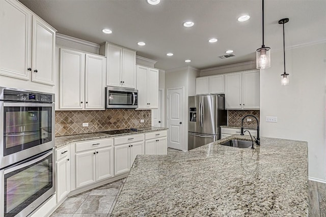 1512 Berlin Ln, Austin, TX 78753 - kitchen featuring appliances with stainless steel finishes, crown molding, recessed lighting, white cabinetry, and decorative backsplash