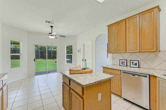 7008 Wandering Oak Rd, Austin, TX 78749 - kitchen with dishwasher, arched walkways, tasteful backsplash, ceiling fan, and a center island