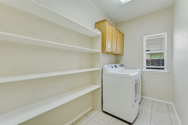 7008 Wandering Oak Rd, Austin, TX 78749 - laundry room featuring washing machine and clothes dryer, cabinet space, and light tile patterned floors
