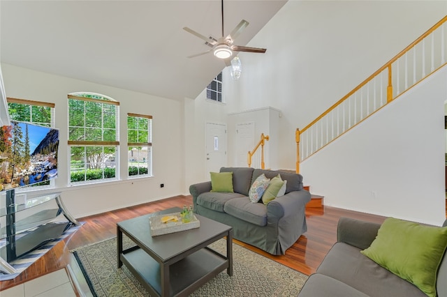 7008 Wandering Oak Rd, Austin, TX 78749 - living room featuring high vaulted ceiling, stairway, ceiling fan, and wood finished floors
