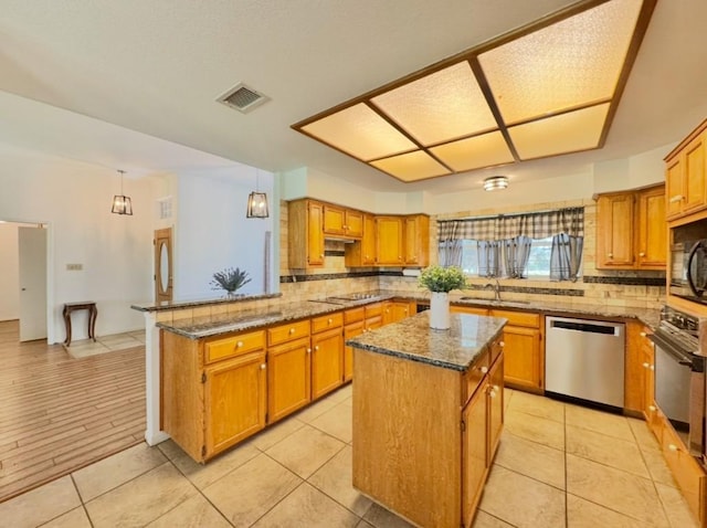 224 Crooked Hollow Dr, Elgin, TX 78621 - kitchen featuring black appliances, backsplash, a peninsula, and dark stone countertops