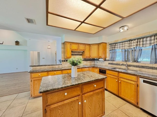 224 Crooked Hollow Dr, Elgin, TX 78621 - kitchen with stainless steel dishwasher, light tile patterned floors, a kitchen island, and tasteful backsplash