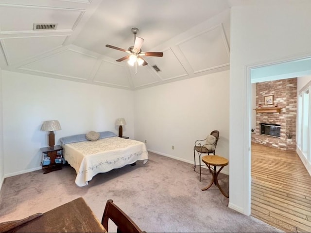 224 Crooked Hollow Dr, Elgin, TX 78621 - bedroom with attic access, carpet flooring, a fireplace, vaulted ceiling, and ceiling fan