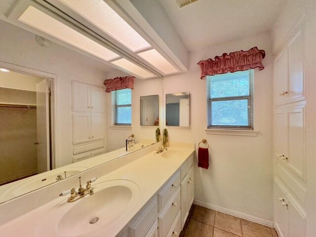 224 Crooked Hollow Dr, Elgin, TX 78621 - bathroom with double vanity, tile patterned floors, and a walk in closet