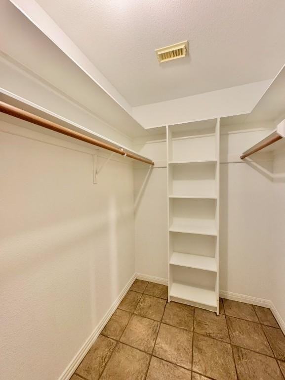 224 Crooked Hollow Dr, Elgin, TX 78621 - walk in closet with light stone finish flooring