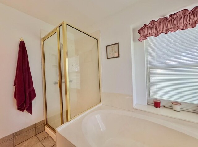 224 Crooked Hollow Dr, Elgin, TX 78621 - bathroom featuring a garden tub, a shower stall, and tile patterned floors